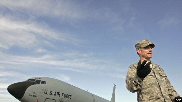 A U.S. officer on the runway at the Manas air base