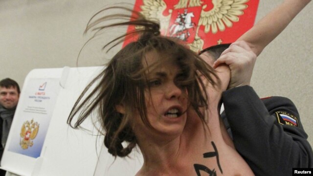 A policeman detains a protester in Moscow in March.