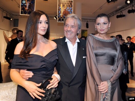 Lola Karimova-Tillyaeva (right) with French actor Alain Delon and Italian actress Monica Bellucci (left) pose before attending a gala dinner for the launch of the charity fund 'Uzbekistan 2020' in Paris in 2009.