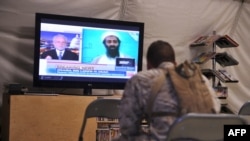 U.S. Marines watch TV announcing the death of Osama Bin Laden in May 2011