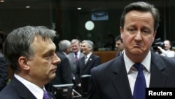 Hungary's prime minister, Viktor Orban (left), talks with British Prime Minister David Cameron at a European Union summit in Brussels on January 30.