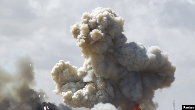 Vehicles belonging to forces loyal to Libyan leader Qaddafi explode after an air strike by coalition forces.
