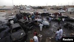 Residents gather at the site of a car bomb attack in Baghdad's Sadr City on May 27.