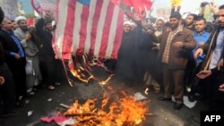 Iranians burn a U.S. flag outside the former U.S. Embassy in Tehran on November 4.