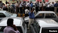 Office workers in Karachi, Pakistan stand outside of their buildings following the earthquake centered in southeastern Iran on April 16.