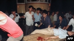 A girl wounded during the clash between the army and students is carried out of Tiananmen Square in 1989.