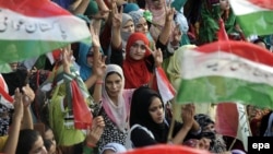 Supporters of opposition cleric Tahirul Qadri listen to him speaking during protests in Islamabad on August 19.