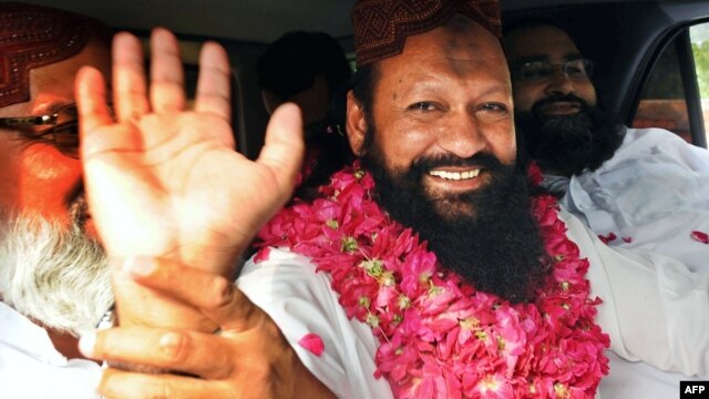 Lashkar-e Jhangvi leader Malik Ishaq waves to supporters in Lahore on July 14.