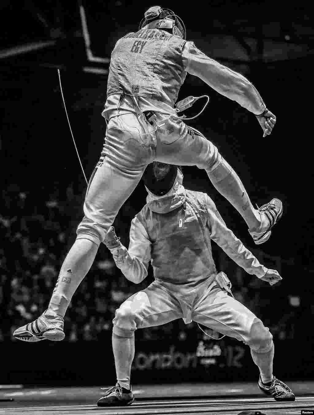 Sergei Ilnitsky of Russia, a photographer working for the European Pressphoto Agency, won second prize in the Sports Action Stories category with the series "The Golden Touch -- Fencing at the Olympics." This picture shows Alaaeldin Abouelkassem of Egypt (top) in action against Peter Joppich of Germany during their Men's Foil Individual round 16 bout at the 2012 Olympic Games in London.