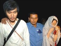 Freed hostages walk with a Red Cross official after their release (AFP)