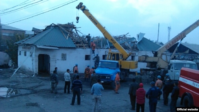 Authorities try to remove and sift through damage on November 3 after a roof collapsed at the Kara-Suu market in the Osh region of southern Kyrgyzstan.