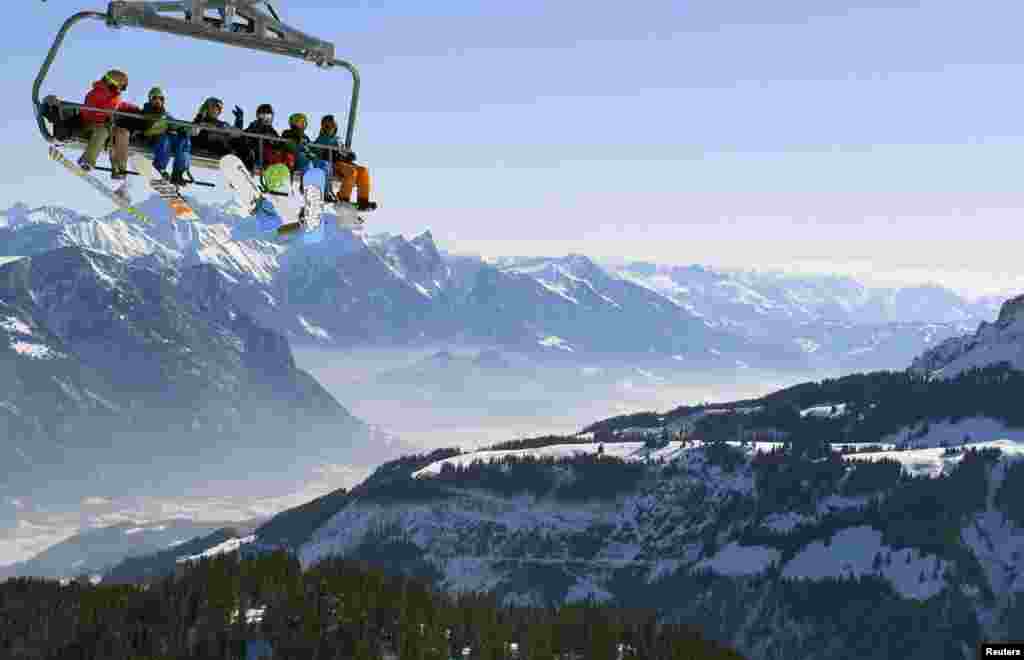 Skiers on a chairlift at the Flumserberg ski area in the Swiss Alps. (Reuters/Arnd Wiegmann)