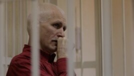 Ales Byalyatski sits in a Minsk court during his trial in November 2011.