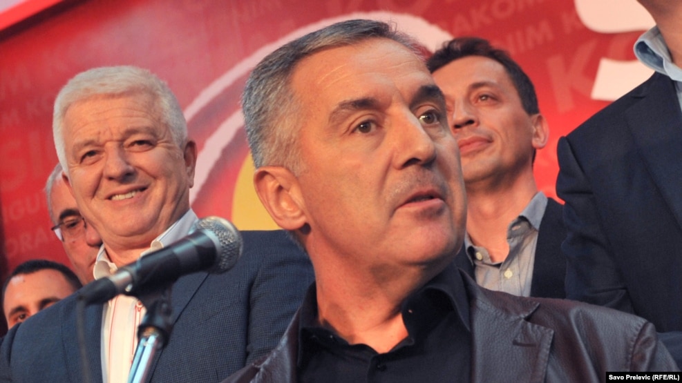 Montenegro's outgoing Prime Minister Milo Djukanovic (center), with close ally Dusko Markovic (left), who was named to succeed him