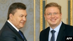 Ukrainian President Viktor Yanukovych (left) and European Enlargement Commissioner Stefan Fuele in Kyiv on February 8.