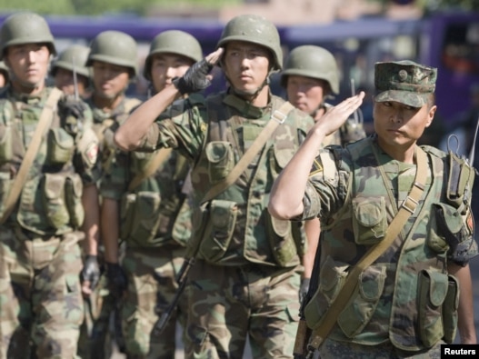 Kyrgyz Army soldiers march in formation in  the city of Osh on June 29.