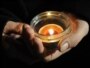 Slovakia --  A woman holds a candle to pay tribute to late former Czech President Vaclav Havel at the centre of the Slovak capital city Bratislava, 19Dec2011