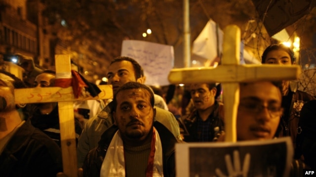 Egyptian Coptic Christians demonstrate outside the state radio and television building in central Cairo on March 8 to protest the burning of a church after deadly clashes between Christians and Muslims in a southern city.