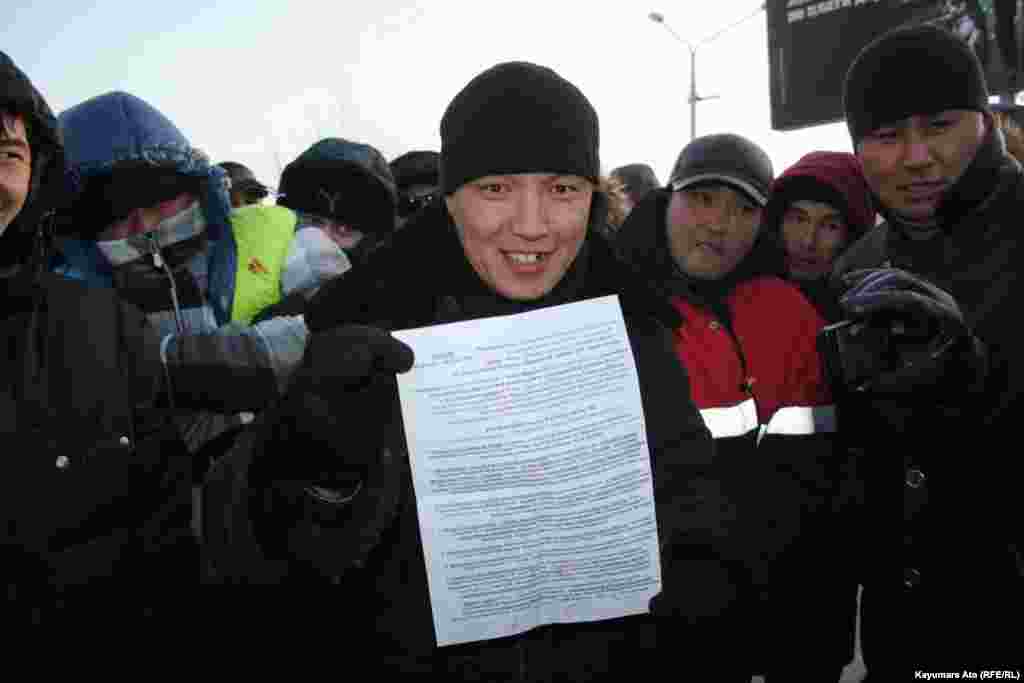 Protesters in Aktau present a list of their demands. 
