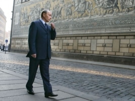 Vladimir Putin walks along a street in Dresden, where he was stationed from 1985 to 1990.