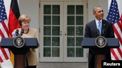 U.S. President Barack Obama (right) and German Chancellor Angela Merkel address a joint news conference in the Rose Garden of the White House in Washington on May 2.