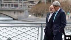 Iranian Foreign Minister Mohammad Javad Zarif (left) was criticized by hard-liners back home for taking a stroll with U.S. Secretary of State John Kerry during a break in nuclear negotiations in Geneva in January.