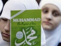 A Muslim girl holds a copy of a book on the Prophet Muhammad in New York City (AFP)