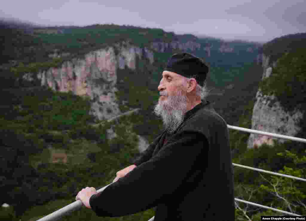 Maxime stands by the railing atop the Katskhi Pillar enjoying the beautiful view on June 18, 2013.