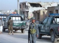 Police outside Kandahar's main jail, where a suicide bombing launched an attack that freed as many as 900 inmates (AFP)