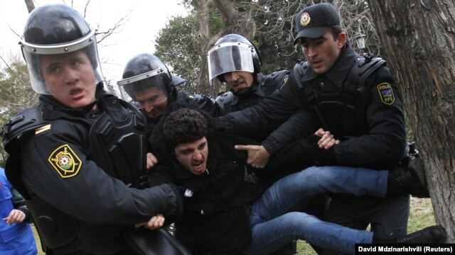 Police detain a man who was protesting in solidarity with Ismayilli residents after a riot in Baku on January 26.