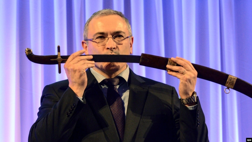 Russian former oil tycoon Mikhail Khodorkovsky receives a replica of a saber after he was awarded with the Knight of Freedom award by the Kazimierz Pulaski Foundation in Warsaw on December 3.