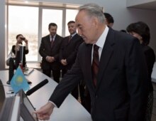 Kazakhstan -- President Nursultan Nazarbaev presses a button on a touch-screen monitor in the control centre of the Atasu-Alashenkou pipeline in Astana, 15 Dec. 2005