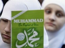 U.S. -- A Muslim girl holds a copy of a book on the Islamic Prophet Muhammad in New York City, 17Feb2006