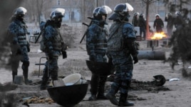 Riot police patrol Zhanaozen in December.