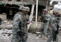 U.S. troops survey the aftermath of a suicide bombing in Mosul today that killed five people (epa)