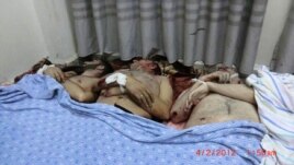 A picture posted on February 4 by the Syrian opposition allegedly shows victims killed in the shelling of a residential district of Homs on February 3.
