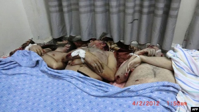 A picture posted on February 4 by the Syrian opposition allegedly shows victims killed in the shelling of a residential district of Homs on February 3.