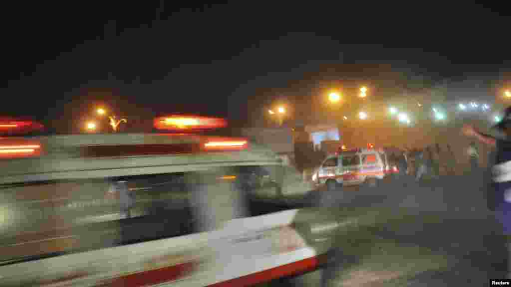 Pakistani rescue workers and ambulances gather at the site of the second of two bomb blasts in Karachi on November 21. (Reuters)