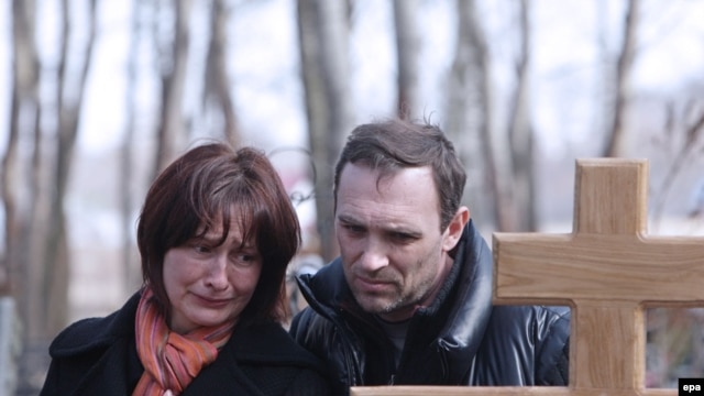 The parents of Maksim Mareyev, who was killed by one of the bombings in Moscow's subway on March 29, mourn at his funeral on March 31.