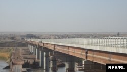 Tajik analysts say a new U.S.-built bridge connecting the country with Afghanistan could be used to extract supplies.