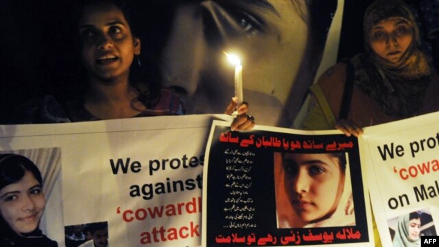 Pakistani activists in Lahore carry candles to pay tribute to gunshot victim Malala Yousafzai and protest against the attempt on her life by the Taliban on October 10.