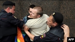 Russian riot policemen detain a gay rights activist during an unauthorized rally in central Moscow earlier this year.