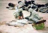 A screen capture from Iraqi television of UN personnel destroying mustard gas in the early 1990s (AFP)
