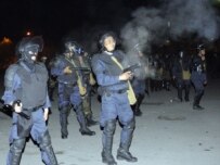 Police and demonstrators clash in Bishkek late on April 19 (ITAR-TASS)