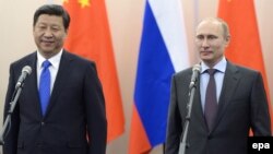 Chinese President Xi Jinping (left) with Russian President Vladimir Putin at a video conference in Bocharov Ruchey residence in Sochi on February 6