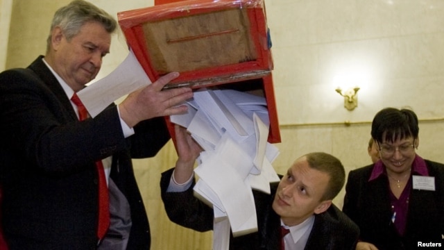 Members of a local election committee emptied a ballot box after polls closed in Minsk in the country's last election, the December 19 presidential vote that sparked protests and a brutal crackdown.