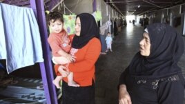 Syrian refugee women wait for the arrival of UN-Arab League peace envoy for Syria at their camp in the border town of Altinozu in Hatay province on September 18.