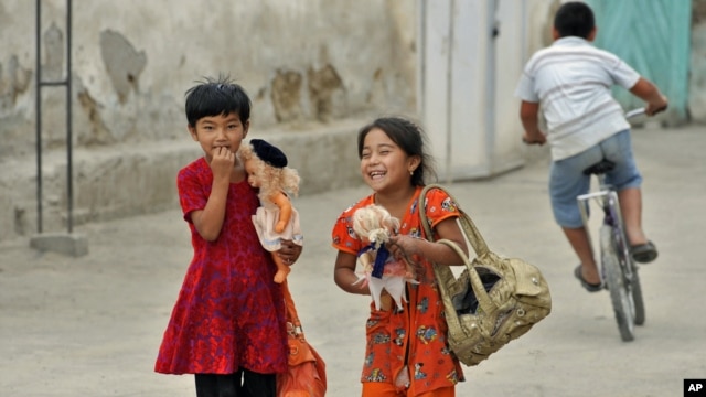 Ethnic Uzbek girls walk along a street just outside the southern city of Osh in June.