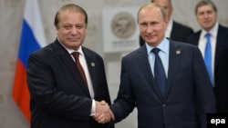 Pakistani Prime Minister Nawaz Sharif (left) shakes hands with Russian President Vladimir Putin during their meeting at the SCO summit in Ufa on July 10.
