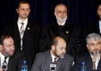 Palestinian Hamas leaders Khalid Mish'al (right), Musa Abu Marzuk (center), and Muhammad Nazal (left) attend a news conference with their bodyguards (standing behind) in Moscow today (epa)